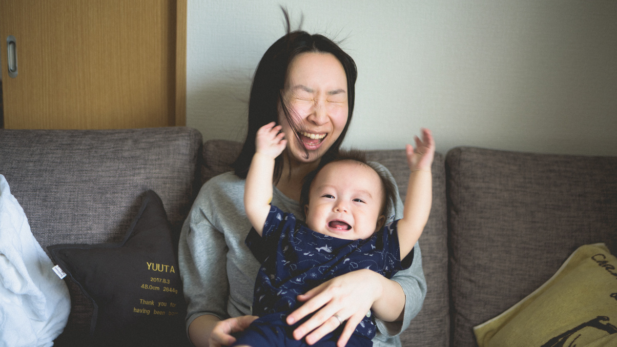 Laughing Japanese Mother and Baby at Home